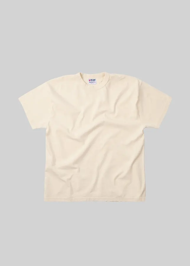 A natural off-white short-sleeve crewneck t-shirt with a woven brand label at the collar, laid flat against a light grey background.
