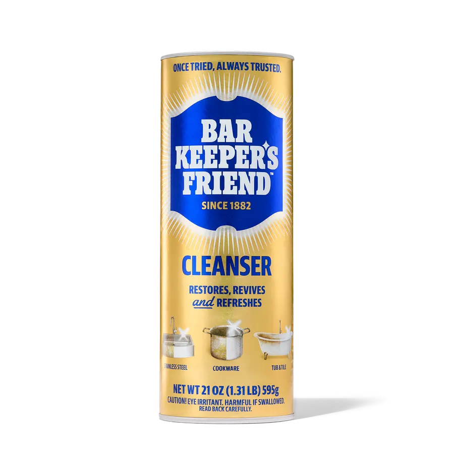 A gold cylindrical can of Bar Keeper's Friend Cleanser powder, front label showing the blue shield logo, 'Restores, Revives and Refreshes', and a 21 oz net weight, on a white background.