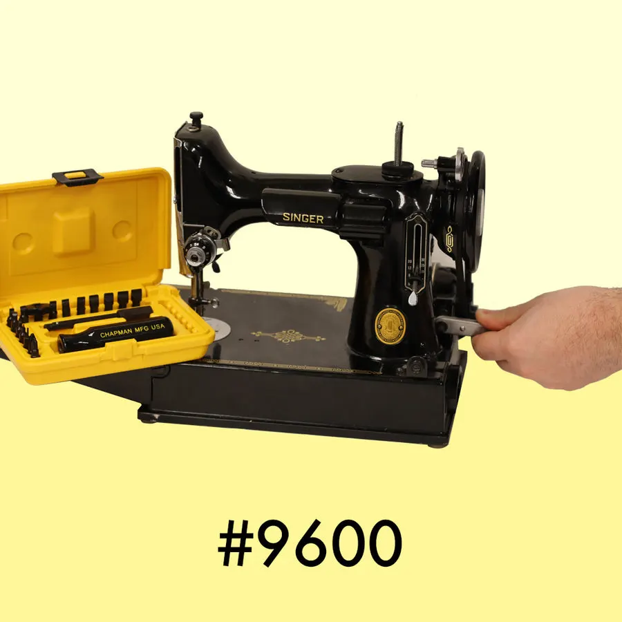 A hand turning a small black Chapman ratchet screwdriver against a vintage black Singer sewing machine, with an open yellow Chapman bit case sitting beside the machine.