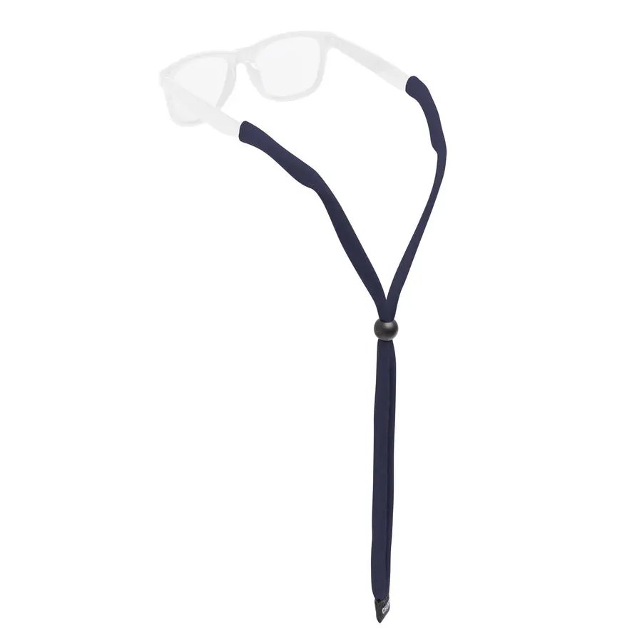 A navy cotton eyewear retainer strap with an adjustable black bead, clipped onto the temple tips of a pair of clear-lensed glasses, shown against a white background.