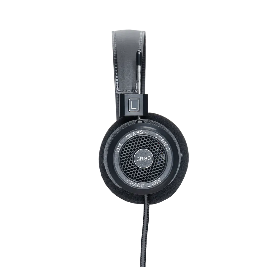 A black over-ear Grado SR80 headphone with foam ear cushions and a woven cable, shown from the side against a white background.
