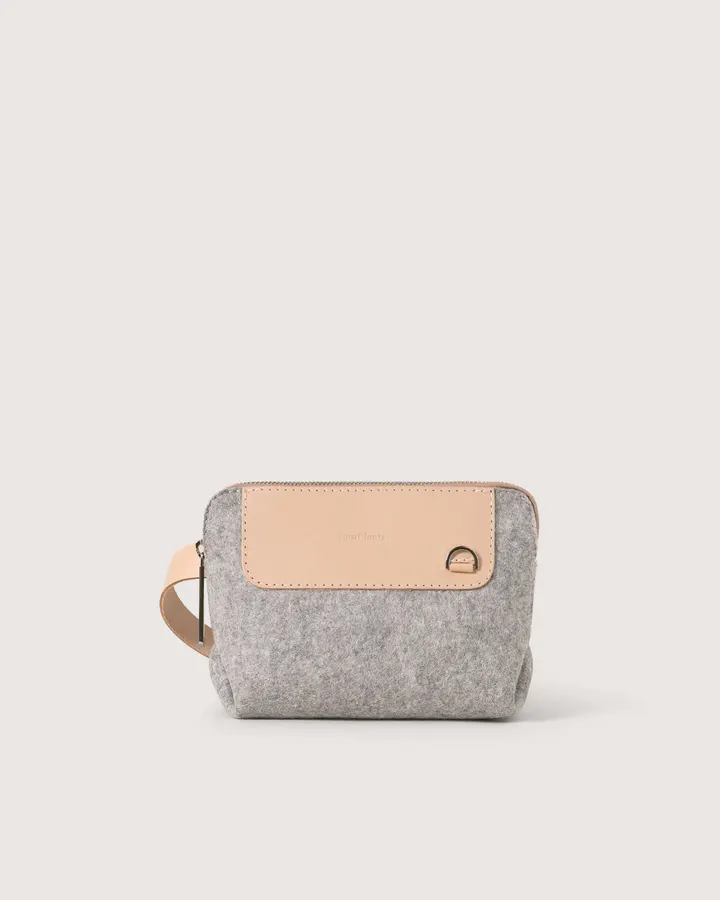 A small heather-grey felt belt bag with a tan leather zip flap and wrist strap, shown front-on against a white background.