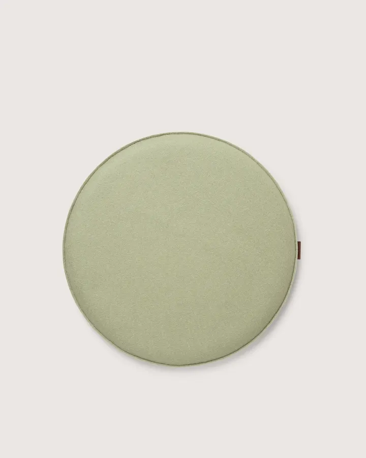 A round sage-green felt seat cushion shown flat against a white background.