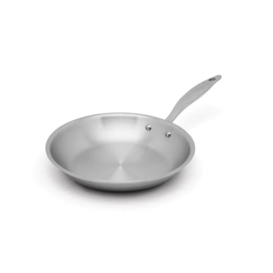 An empty stainless steel Heritage Steel fry pan with a long riveted handle, shown at an angle against a white background.