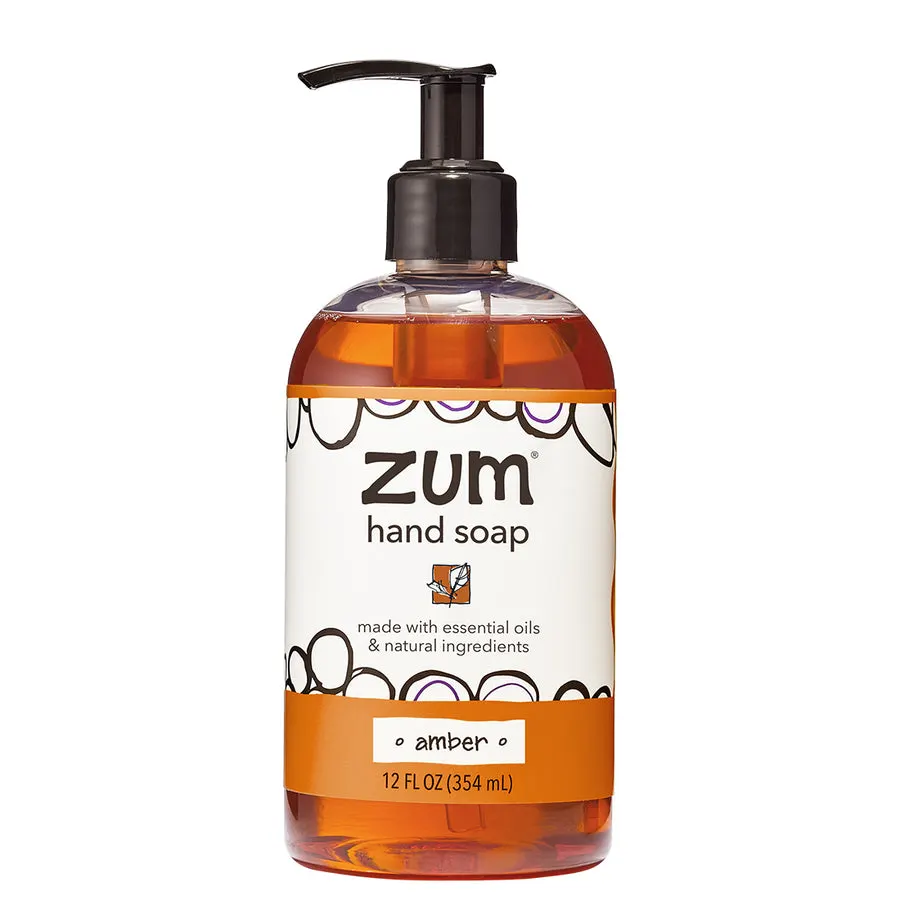 A clear pump bottle of amber-colored Zum hand soap with a black pump top, labeled "amber", 12 fl oz, against a white background.