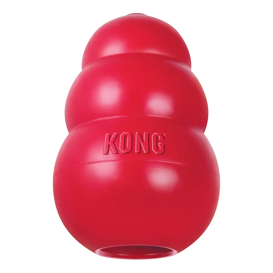 A red rubber KONG Classic dog toy with its signature three-tier hourglass shape and embossed KONG logo, shot against a plain white background.