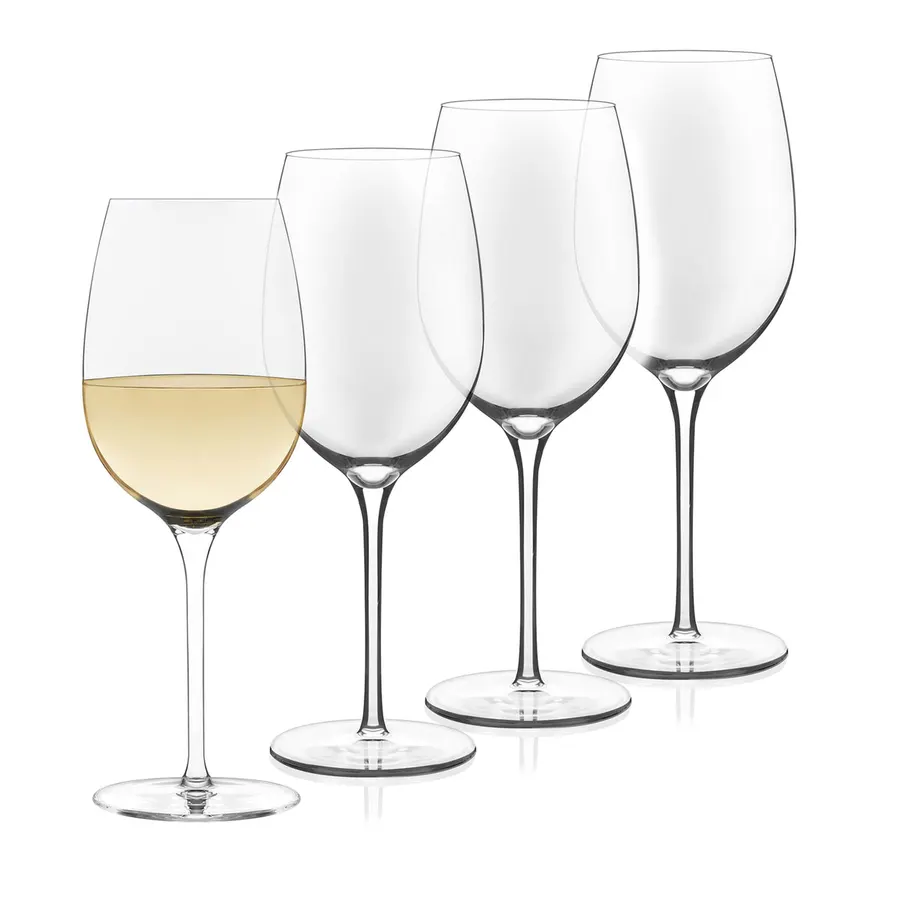 Four stemmed wine glasses in a row, the front one filled with white wine, against a white background.