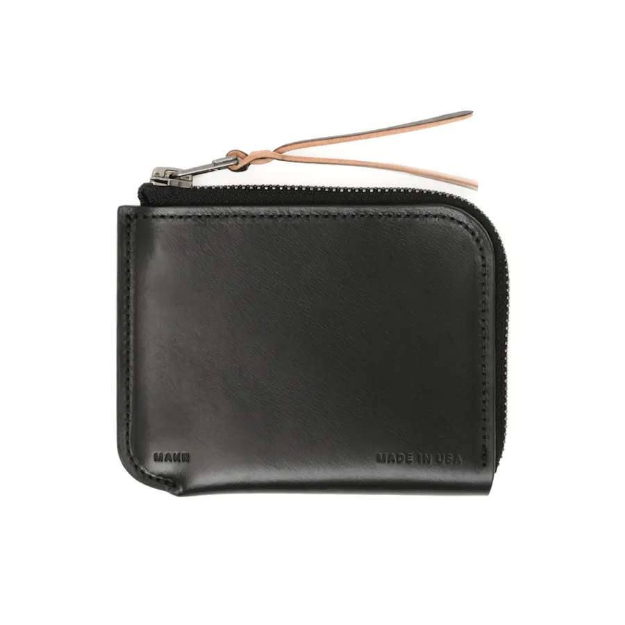 A black leather zip-around wallet with a tan leather zipper pull, embossed 'MAKR' and 'Made in USA', on a white background.