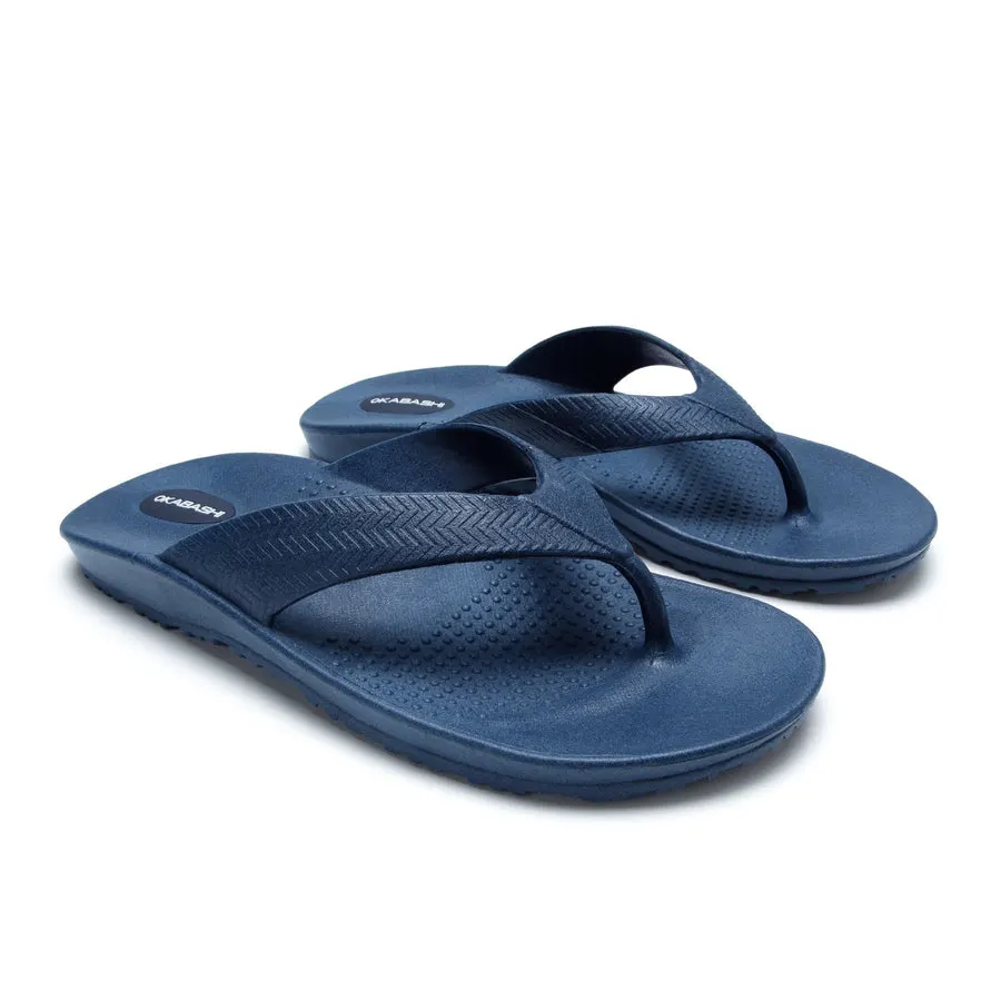 A pair of navy blue rubber flip-flops with a textured chevron-pattern strap, shown at a three-quarter angle against a plain white background.
