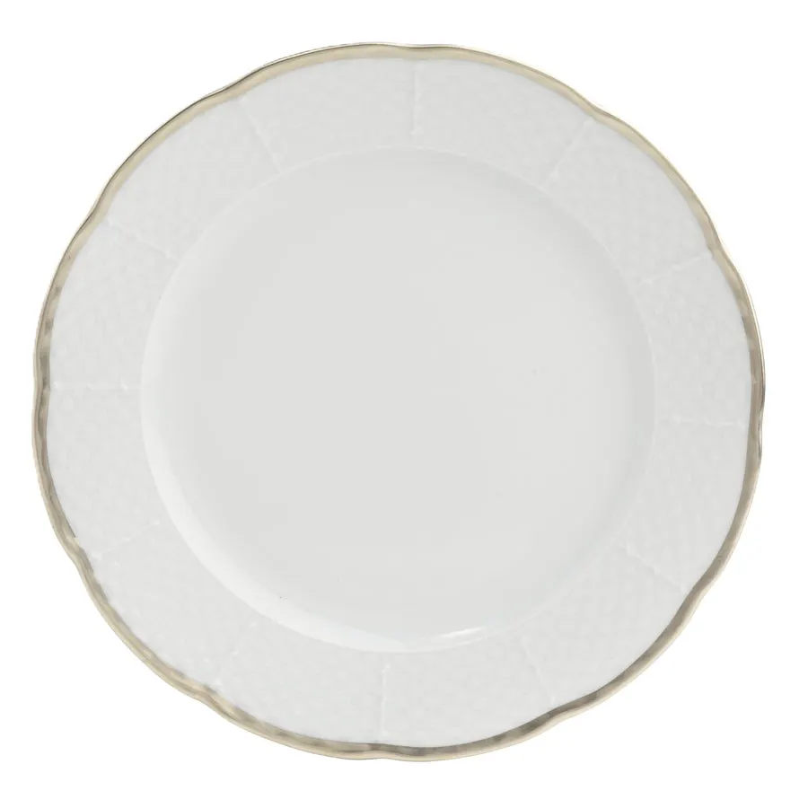 A white bone china dinner plate with a scalloped edge, a basketweave-textured rim, and a thin platinum trim, shot on white.