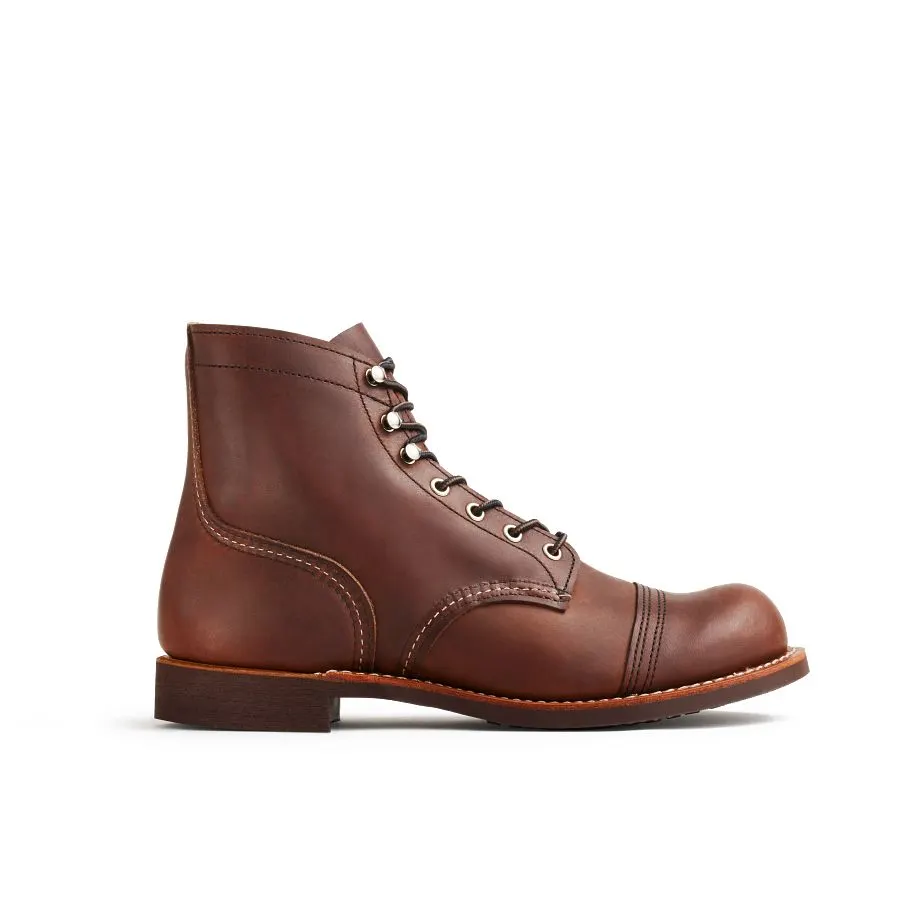 A single dark amber leather cap-toe work boot with a stacked leather heel, shown in profile against a plain white studio background.