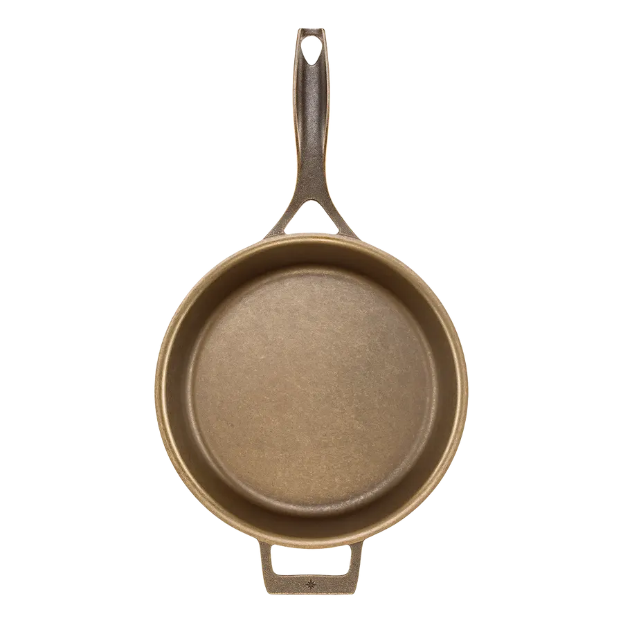 An empty bronze-finished 12-inch cast iron skillet with a long loop handle and a small pour-spout opposite handle, photographed from directly above against a white background.